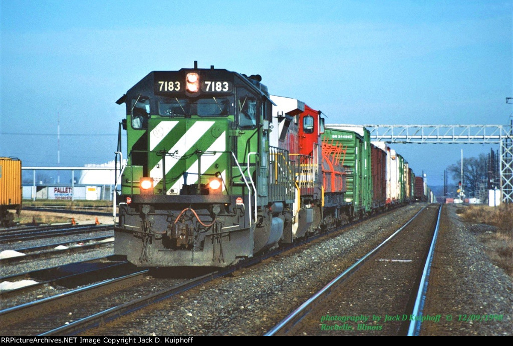 Burlington Northern, BN SD40-2 7183 leads a eastbound at, Rochelle, Illinois. December 9, 1998. Jack D Kuiphoff © photo